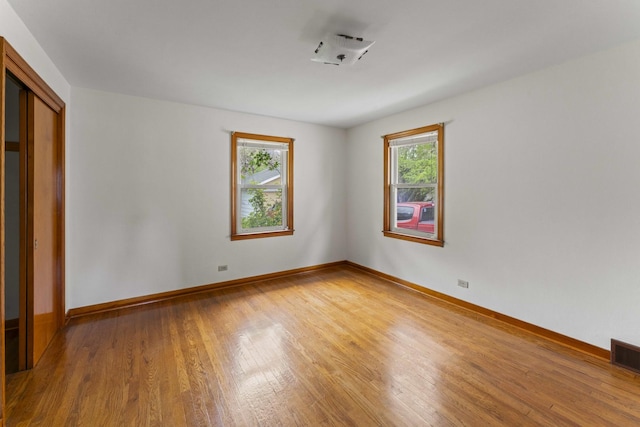 341 W Glen Flora Ave, Waukegan, IL 60085 - unfurnished bedroom featuring light wood-type flooring, baseboards, and a closet