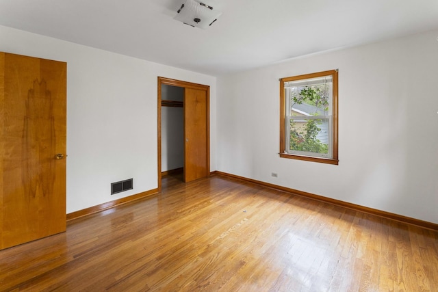 341 W Glen Flora Ave, Waukegan, IL 60085 - unfurnished bedroom with light wood-style flooring, a closet, and baseboards