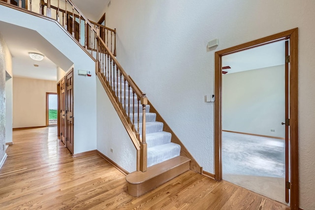 1574 Crowfoot Cir, Hoffman Estates, IL 60169 - stairs featuring wood finished floors, baseboards, and a textured wall