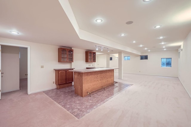 1574 Crowfoot Cir, Hoffman Estates, IL 60169 - kitchen featuring light carpet, glass insert cabinets, a kitchen island, brown cabinets, and baseboards