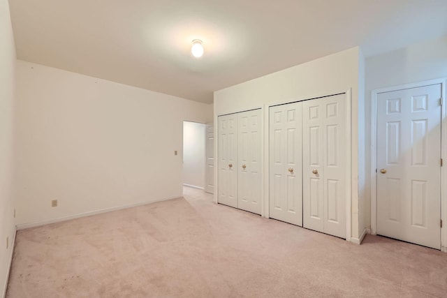 1574 Crowfoot Cir, Hoffman Estates, IL 60169 - unfurnished bedroom featuring two closets, light colored carpet, and baseboards