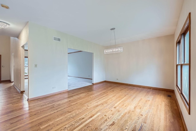 1574 Crowfoot Cir, Hoffman Estates, IL 60169 - unfurnished room featuring wood finished floors, a chandelier, and baseboards