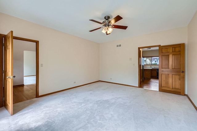 1574 Crowfoot Cir, Hoffman Estates, IL 60169 - spare room with light carpet, a ceiling fan, and baseboards