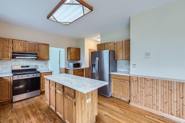 1574 Crowfoot Cir, Hoffman Estates, IL 60169 - kitchen featuring appliances with stainless steel finishes, under cabinet range hood, light countertops, light wood finished floors, and a center island