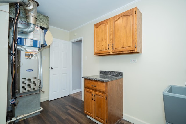 458 Tahoe St, Park Forest, IL 60466 - kitchen featuring dark wood-type flooring, baseboards, ornamental molding, dark countertops, and brown cabinetry