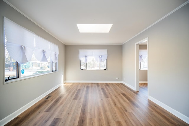 458 Tahoe St, Park Forest, IL 60466 - spare room with crown molding, a skylight, wood finished floors, and baseboards