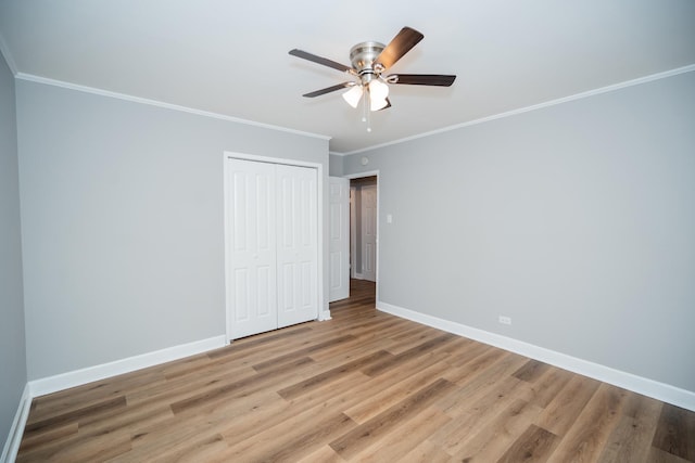 458 Tahoe St, Park Forest, IL 60466 - unfurnished bedroom with a closet, crown molding, light wood-style floors, baseboards, and a ceiling fan