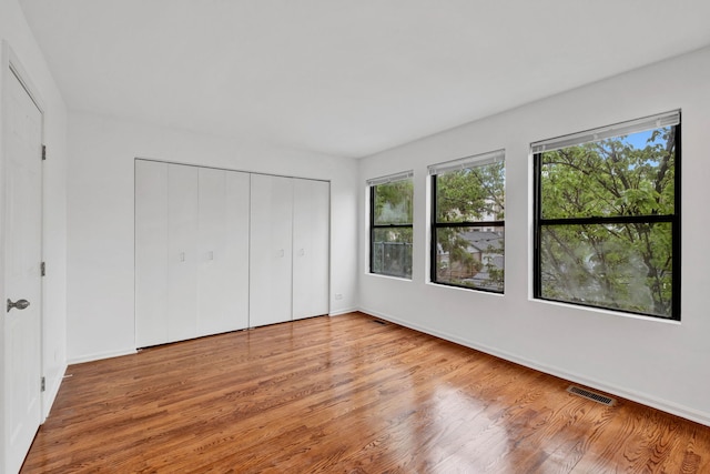 1815 N Bissell St Unit 3, Chicago, IL 60614 - unfurnished bedroom featuring wood finished floors, baseboards, and a closet