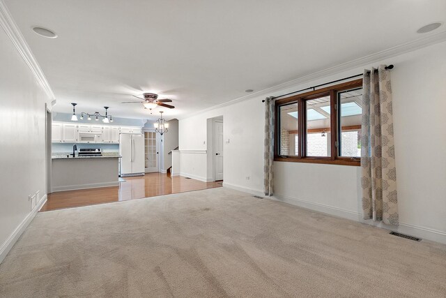 8144 Bunker Dr, Orland Park, IL 60462 - unfurnished living room featuring crown molding, light colored carpet, a chandelier, ceiling fan, and baseboards