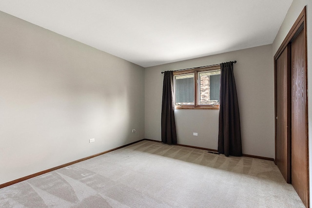 8144 Bunker Dr, Orland Park, IL 60462 - unfurnished bedroom featuring light colored carpet, baseboards, and a closet