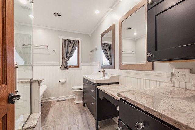 8144 Bunker Dr, Orland Park, IL 60462 - bathroom featuring ornamental molding, toilet, wainscoting, and vanity