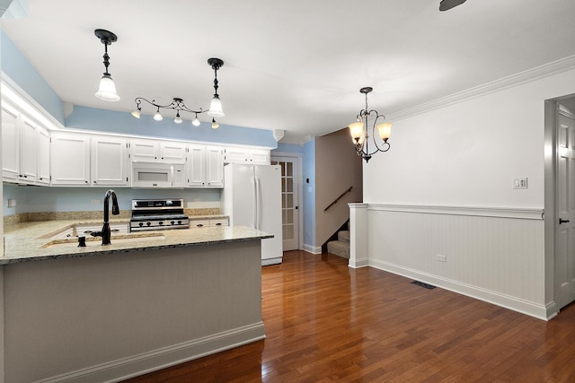 8144 Bunker Dr, Orland Park, IL 60462 - kitchen with white appliances, a sink, dark wood finished floors, wainscoting, and light stone counters