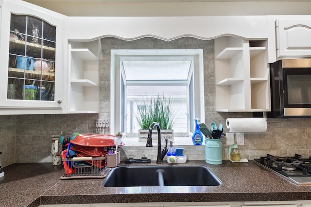 1502 S Mill St, Pontiac, IL 61764 - kitchen with open shelves, a sink, appliances with stainless steel finishes, dark countertops, and white cabinetry