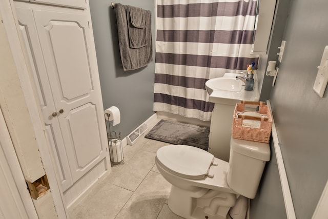 1502 S Mill St, Pontiac, IL 61764 - bathroom featuring toilet, tile patterned flooring, a sink, and baseboards