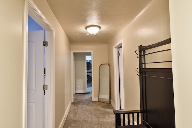 1502 S Mill St, Pontiac, IL 61764 - hallway with estacked washer and dryer, carpet floors, and baseboards