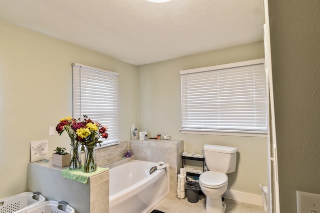 1502 S Mill St, Pontiac, IL 61764 - bathroom featuring a garden tub, toilet, tile patterned floors, and baseboards