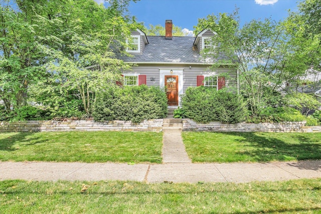 402 S Coler Ave, Urbana, IL 61801 - new england style home featuring a front lawn and a chimney