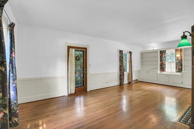 402 S Coler Ave, Urbana, IL 61801 - spare room with wood finished floors and a wainscoted wall