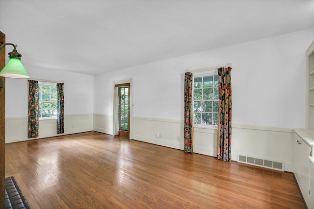 402 S Coler Ave, Urbana, IL 61801 - spare room with wood finished floors and wainscoting