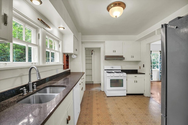 402 S Coler Ave, Urbana, IL 61801 - kitchen with white appliances, under cabinet range hood, white cabinets, light flooring, and dark stone counters