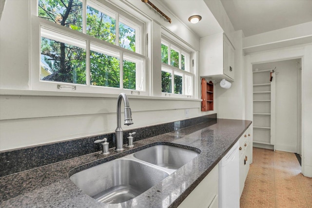 402 S Coler Ave, Urbana, IL 61801 - kitchen with white dishwasher, white cabinets, dark stone countertops, and light tile patterned flooring
