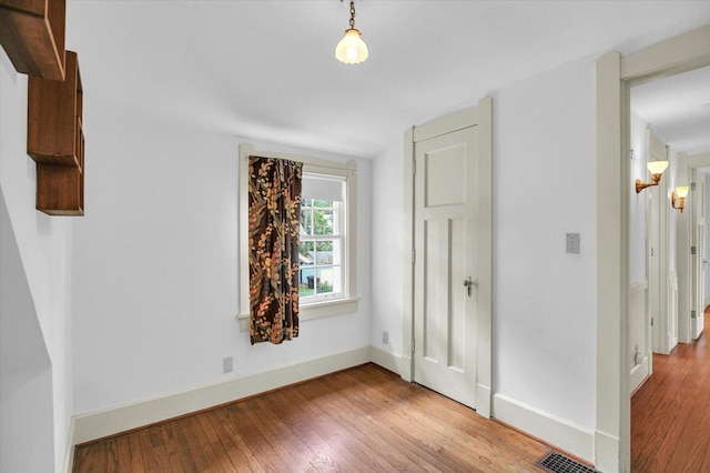 402 S Coler Ave, Urbana, IL 61801 - unfurnished room featuring wood-type flooring and lofted ceiling