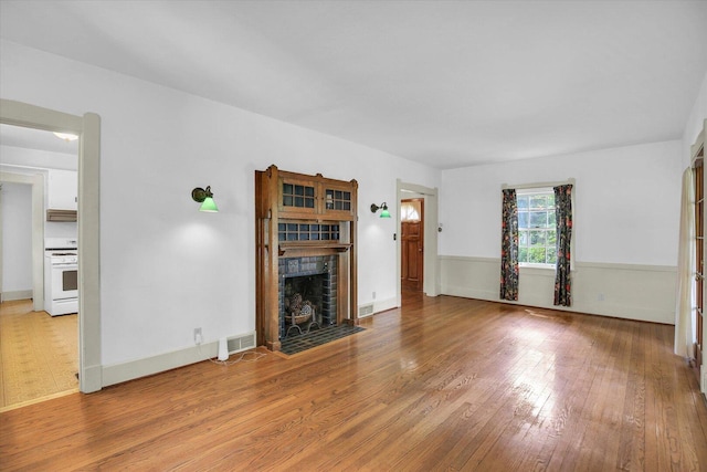 402 S Coler Ave, Urbana, IL 61801 - unfurnished living room featuring a fireplace and wood finished floors
