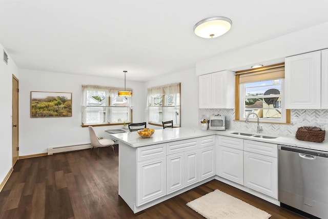 5923 W Giddings St, Chicago, IL 60630 - kitchen with stainless steel dishwasher, a sink, a baseboard radiator, a peninsula, and plenty of natural light