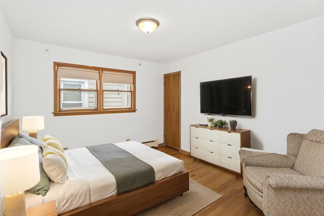 5923 W Giddings St, Chicago, IL 60630 - bedroom featuring wood finished floors and a baseboard radiator