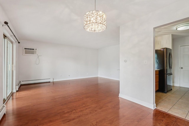 461 N Jonathan Dr Unit 104, Palatine, IL 60074 - empty room featuring a baseboard radiator, a chandelier, an AC wall unit, wood finished floors, and baseboard heating