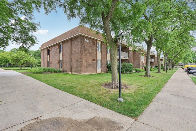 461 N Jonathan Dr Unit 104, Palatine, IL 60074 - view of side of home featuring brick siding and a lawn