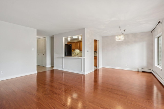 461 N Jonathan Dr Unit 104, Palatine, IL 60074 - unfurnished living room featuring a chandelier and wood finished floors