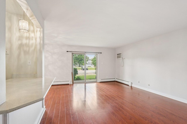 461 N Jonathan Dr Unit 104, Palatine, IL 60074 - spare room with a baseboard radiator, dark wood-style flooring, a chandelier, and a wall mounted AC