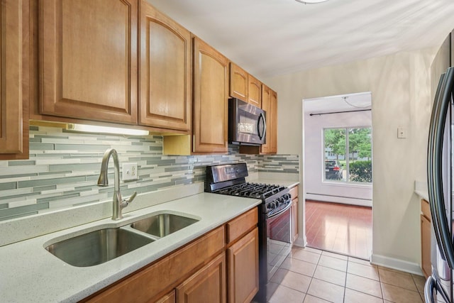 461 N Jonathan Dr Unit 104, Palatine, IL 60074 - kitchen featuring black appliances, decorative backsplash, light tile patterned floors, a baseboard heating unit, and brown cabinets