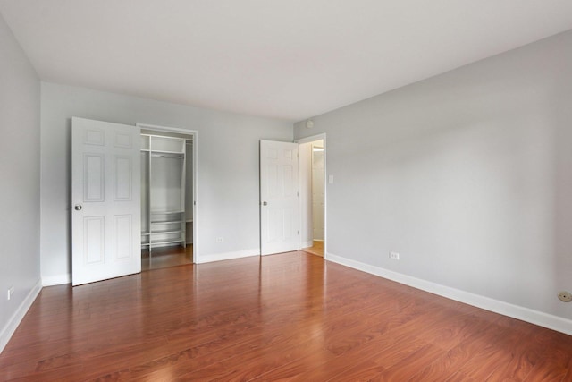 461 N Jonathan Dr Unit 104, Palatine, IL 60074 - unfurnished bedroom with wood finished floors, a closet, and a spacious closet