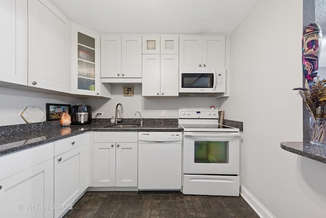 10 E Ontario St Unit 1303, Chicago, IL 60611 - kitchen with white appliances, a sink, white cabinetry, glass insert cabinets, and dark stone countertops