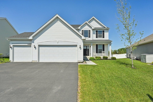 1486 Keller St, Elburn, IL 60119 - traditional-style home with asphalt driveway, an attached garage, a front yard, and a porch