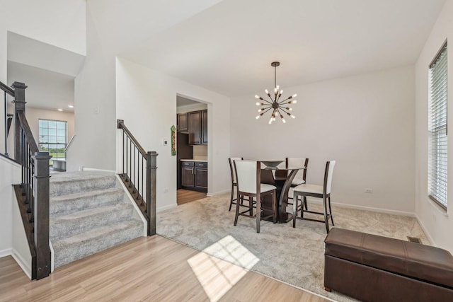 1486 Keller St, Elburn, IL 60119 - dining area featuring light wood-style floors, stairway, and a chandelier