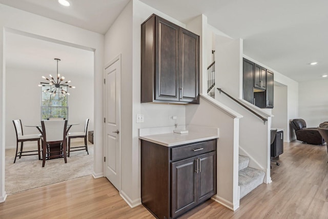 1486 Keller St, Elburn, IL 60119 - kitchen with dark brown cabinetry, light wood finished floors, light countertops, a chandelier, and recessed lighting