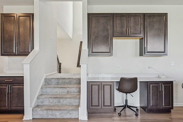 1486 Keller St, Elburn, IL 60119 - stairs with built in study area, wood finished floors, and baseboards