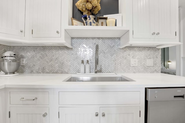1814 N Lincoln Park W Unit 3, Chicago, IL 60614 - kitchen featuring stainless steel dishwasher, a sink, white cabinetry, tasteful backsplash, and light countertops