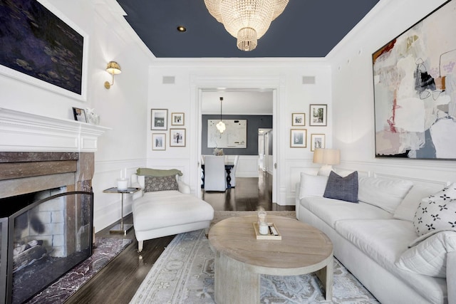 1814 N Lincoln Park W Unit 3, Chicago, IL 60614 - living room featuring a high end fireplace, wood finished floors, ornamental molding, a chandelier, and a wainscoted wall