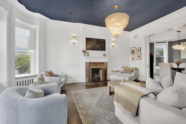 1814 N Lincoln Park W Unit 3, Chicago, IL 60614 - living area with a chandelier, a premium fireplace, a decorative wall, wainscoting, and dark wood-type flooring