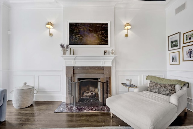 1814 N Lincoln Park W Unit 3, Chicago, IL 60614 - bedroom with a decorative wall, wood finished floors, a fireplace with raised hearth, ornamental molding, and wainscoting