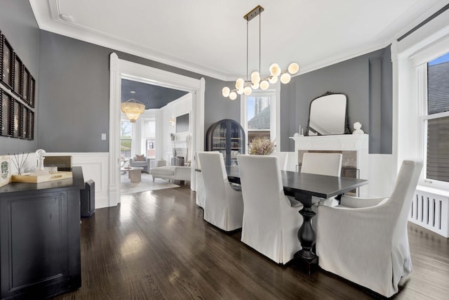 1814 N Lincoln Park W Unit 3, Chicago, IL 60614 - dining area with a decorative wall, crown molding, a wainscoted wall, and dark wood-style floors