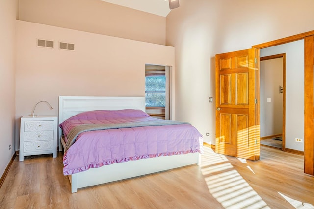 971 Heathrow Ln, Naperville, IL 60540 - bedroom featuring a towering ceiling, wood finished floors, and baseboards