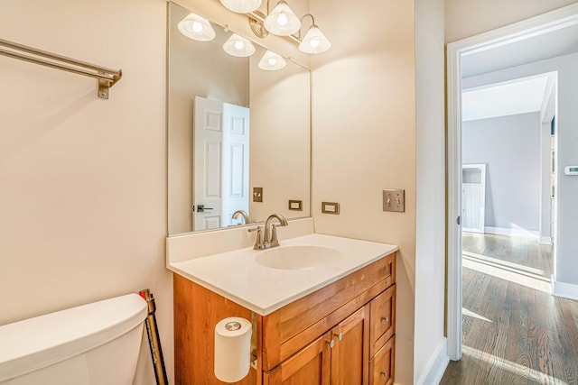 971 Heathrow Ln, Naperville, IL 60540 - half bath featuring wood finished floors, toilet, vanity, and baseboards