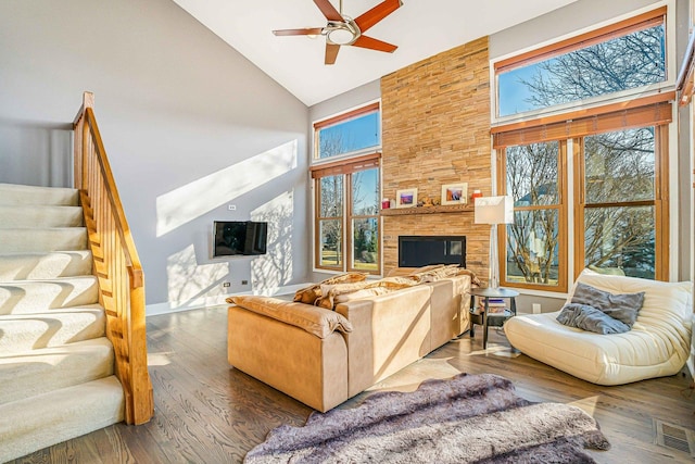971 Heathrow Ln, Naperville, IL 60540 - living room with high vaulted ceiling, healthy amount of natural light, ceiling fan, a fireplace, and stairs
