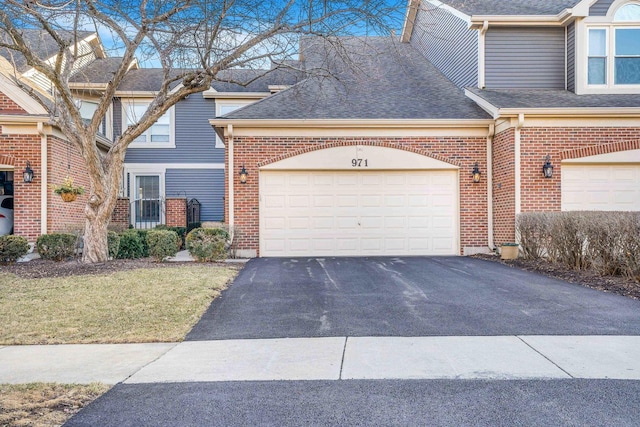 971 Heathrow Ln, Naperville, IL 60540 - traditional home with asphalt driveway, brick siding, roof with shingles, an attached garage, and a front yard