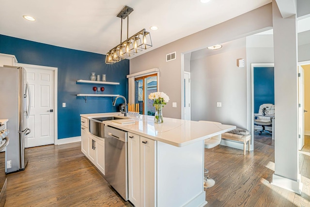 971 Heathrow Ln, Naperville, IL 60540 - kitchen featuring a sink, appliances with stainless steel finishes, white cabinets, a center island with sink, and dark wood-style flooring